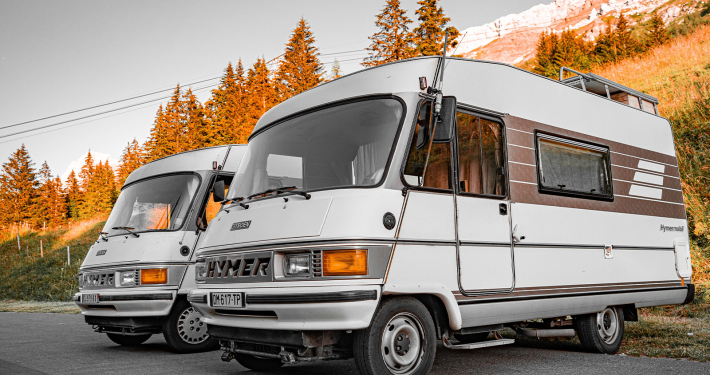 Cheapest Motorhome insurance a twin pair of hymer motorhomes infronts of trees
